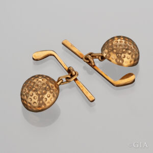 Gold golf inspired cufflinks. Photo by Orasa Weldon/GIA, gift Richard T. Liddicoat Estate