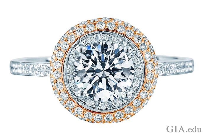 A pavé set diamond halo surrounds a center stone. The diamonds weigh a total of 1.46 carats.