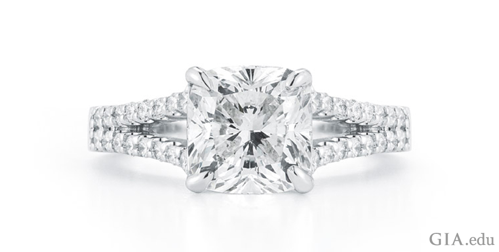 A 14K white gold split-shank engagement ring with a 2.11 ct cushion cut center stone