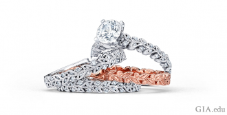 A rose gold band adds a dramatic splash of color when bracketed between two bands in white gold. A subtle touch: The pattern in the rose gold ring is echoed in the diamond wedding bands.