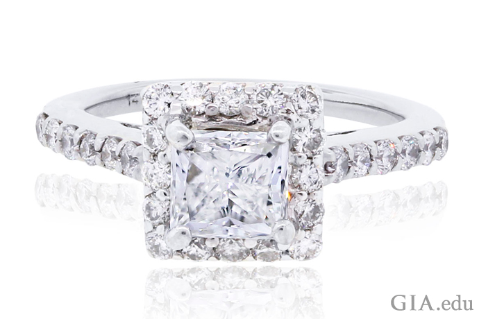 An H-color, VS2 clarity, 1.10 ct princess cut diamond engagement ring surrounded by 0.96 carats of diamond melee.