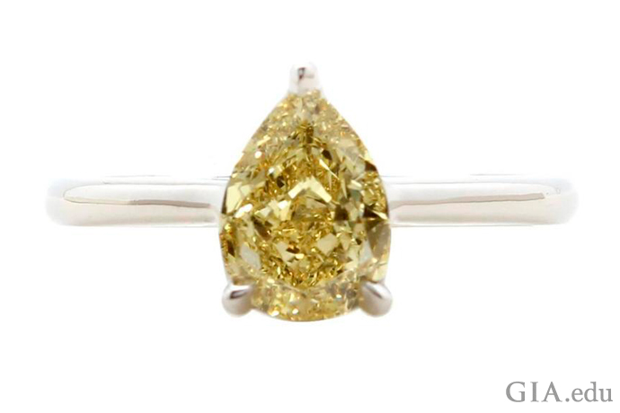 A 1.39 carat fancy yellow pear shaped diamond engagement ring.