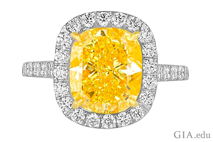 A 4.76 ct Fancy Vivid yellow diamond engagement ring surrounded by