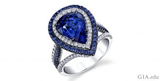 A pear shaped sapphire surrounded by colorless diamonds and a second halo of sapphires.