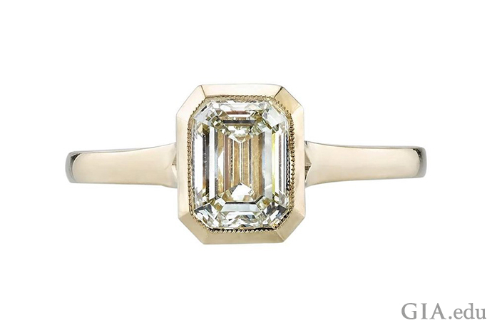 An N-color diamond engagement ring set in a yellow gold.