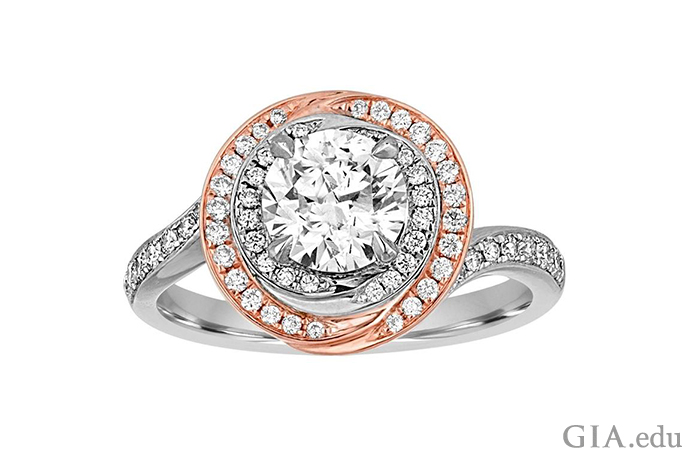 A 1.05 carat round brilliant cut diamond engagement ring with two halos of diamond melee set in 18K white gold and 18K rose gold.