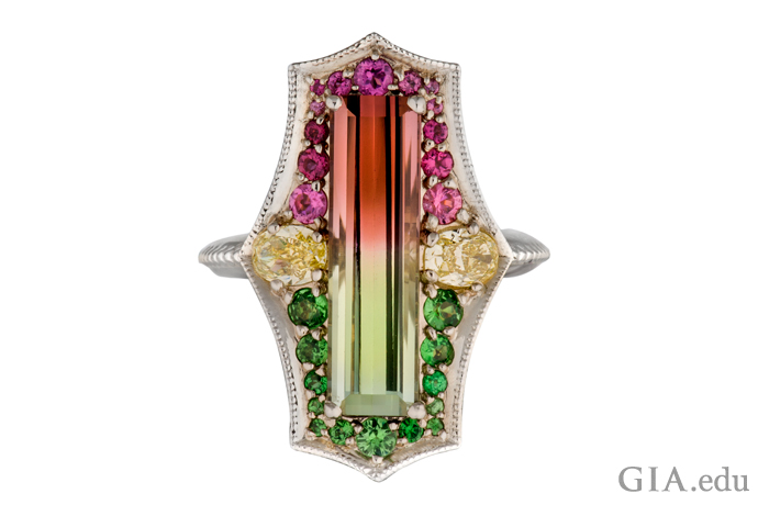 A 9.05 ct bi-colored tourmaline ring set in 14K white gold features yellow diamonds, tsavorites and rubellites.