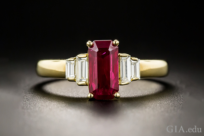 A 1.39 carat elongated emerald-cut Ruby, accented by stepped pairs of bright-white baguette diamonds set in 18K yellow gold.