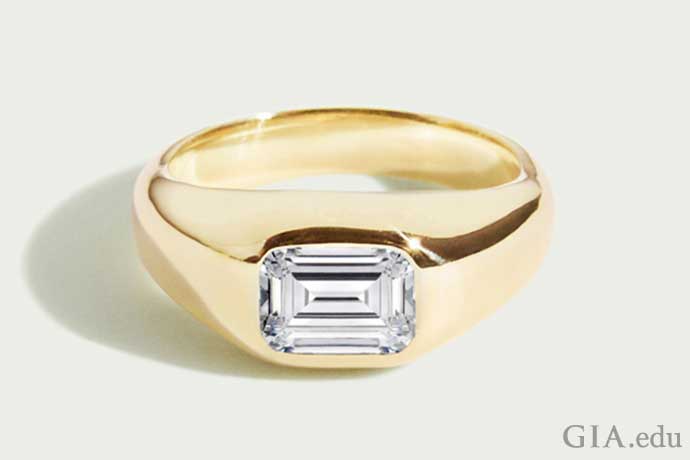 Mens wedding band with an emerald cut diamond center mounted in gold.