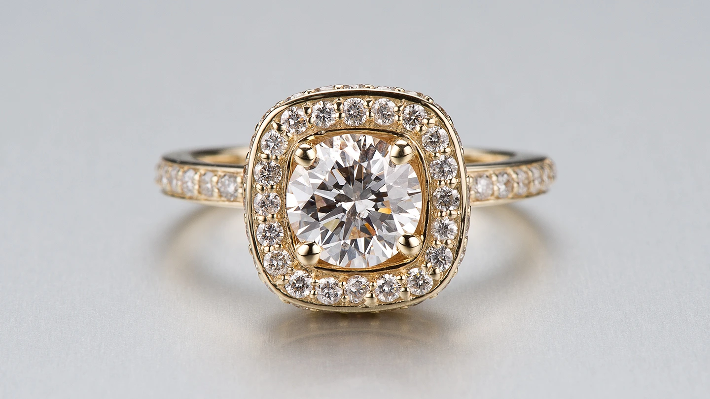 Round brilliant diamond halo ring.