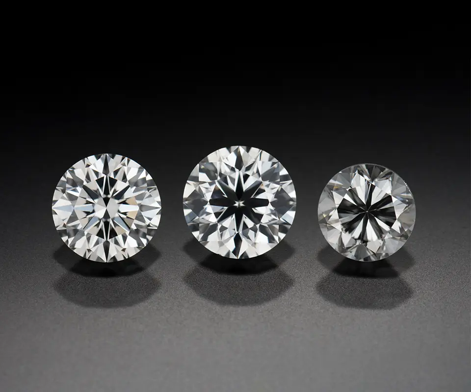 Round brilliant diamonds with different cut grades