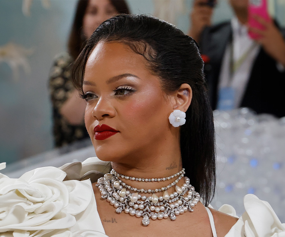 Rihanna wearing diamond and pearl necklace