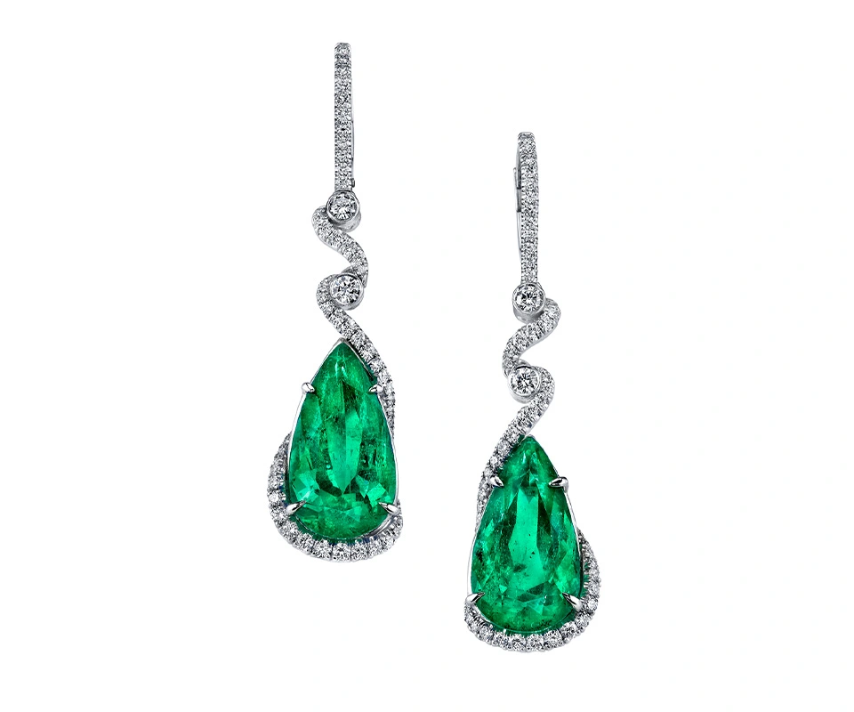 Emerald drop earrings accented by diamonds