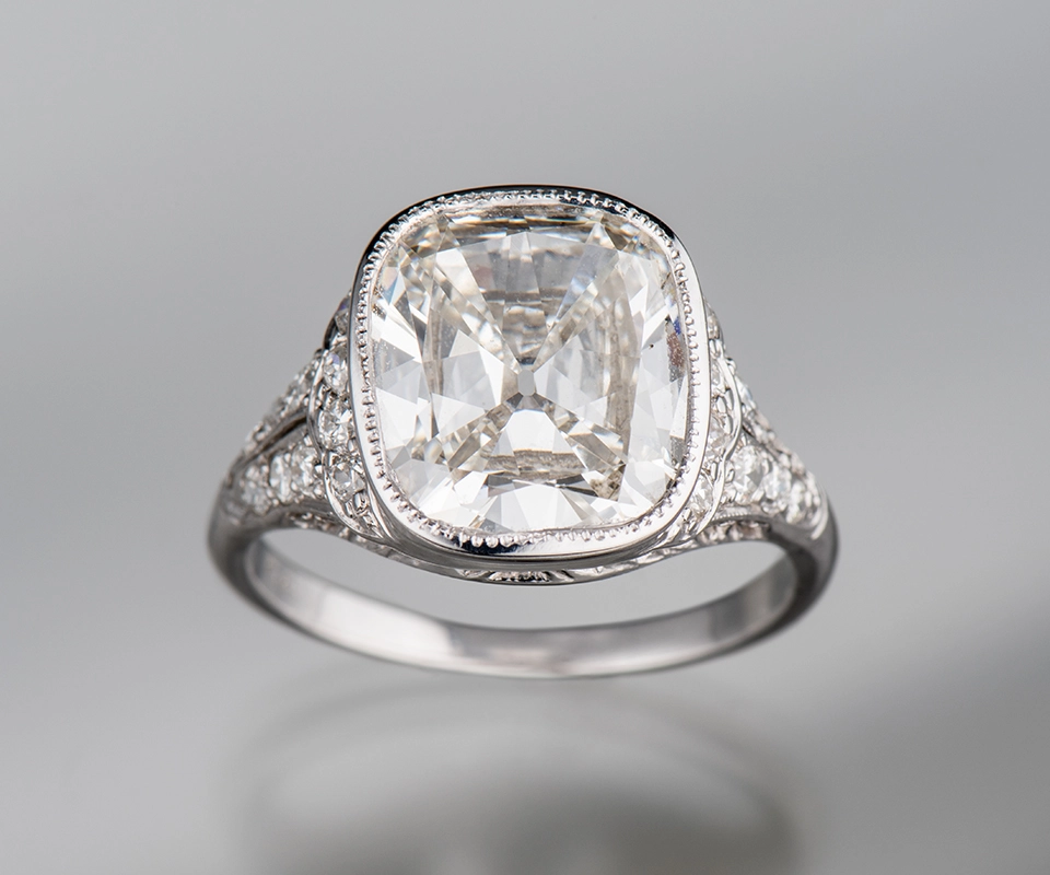 Old mine cut diamond ring on gray background