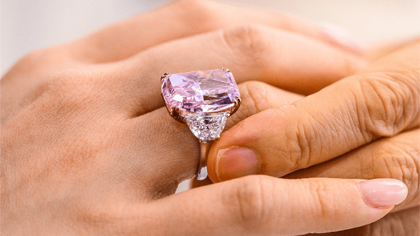 Closeup of woman's hand wearing the Sakura pink diamond ring