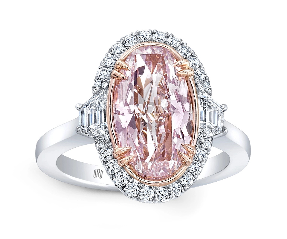 Fancy pink oval diamond ring with diamond halo and trapezoid diamond side stones