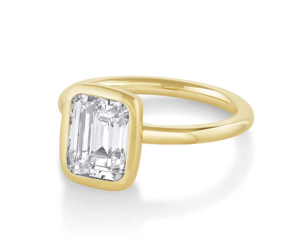 Emerald-cut diamond ring with full bezel setting in yellow gold