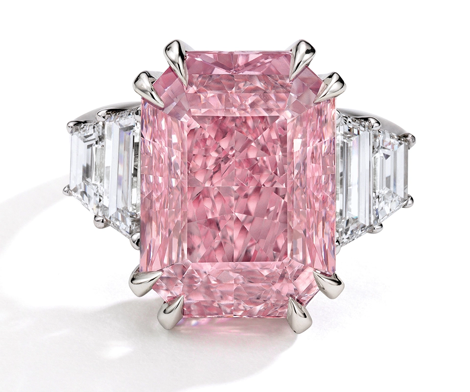 Pink diamond ring with claw prongs and trapezoid side stones