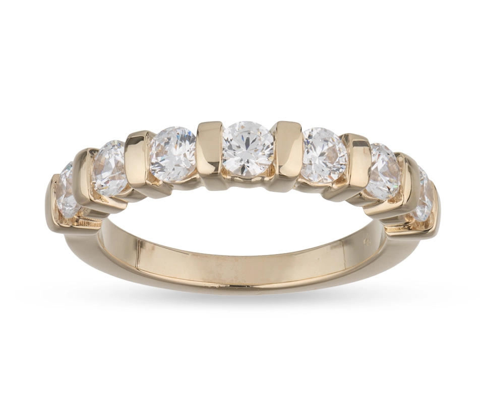 A gold ring with seven round brilliant diamonds secured with bar setting