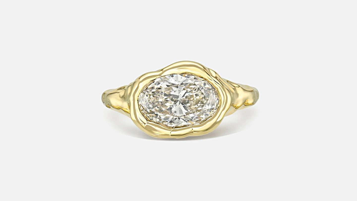 Two-carat, k-color oval diamond set in a melted bezel solitaire ring