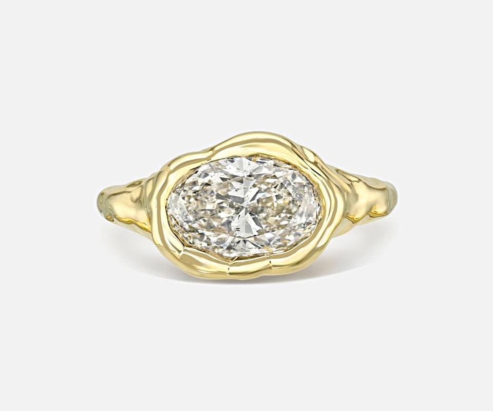 Two-carat, k-color oval diamond set in a melted bezel solitaire ring