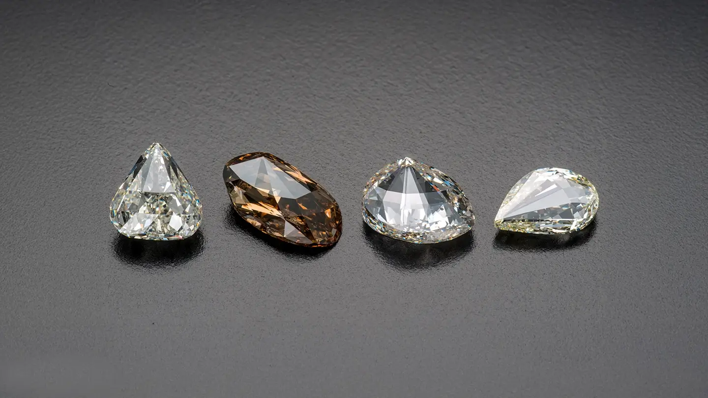 Four seashell cut diamonds ranging from pale yellow to brown