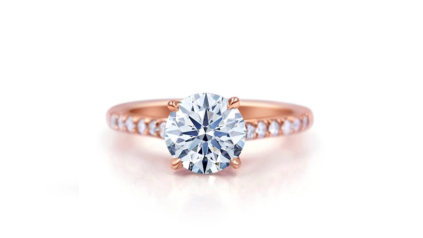 Round brilliant diamond solitaire ring with rose gold pave band