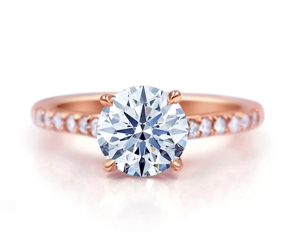 Round brilliant diamond solitaire ring with rose gold pave band