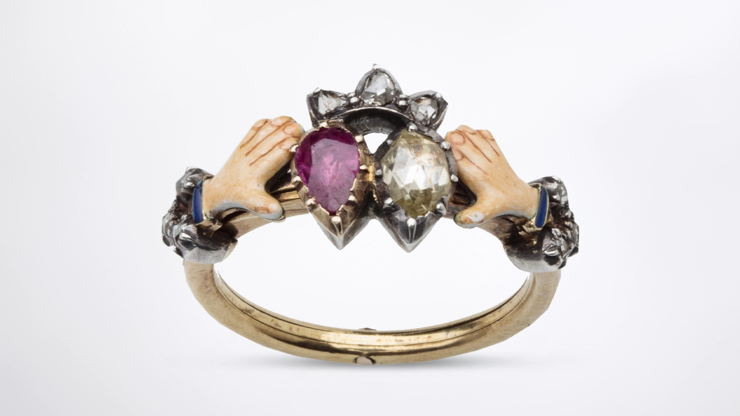 Antique gimmel ring with a ruby and diamond in collet cut down setting