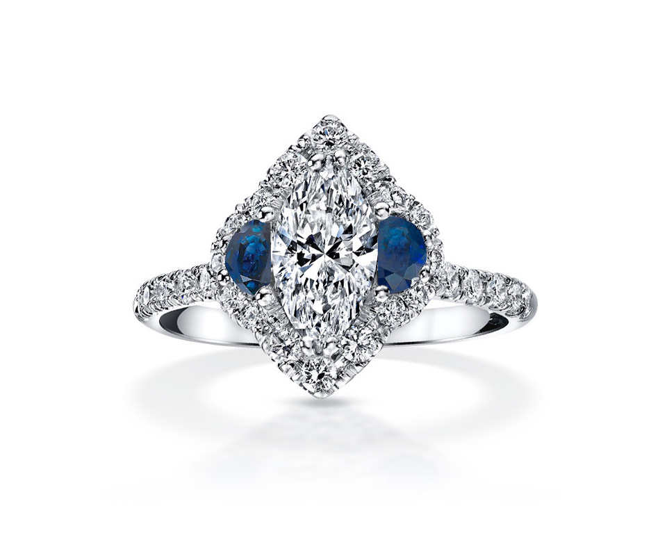 Marquise diamond ring with moon-cut sapphires and diamond pavé halo.