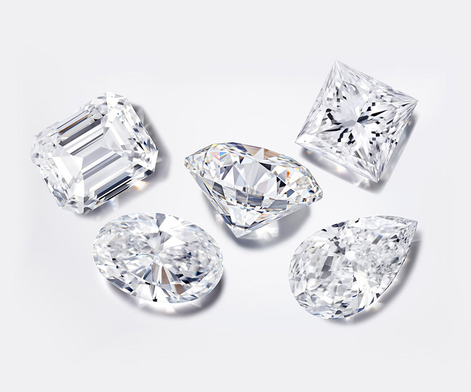 An oval, round, emerald cut and pear-shaped colorless diamond